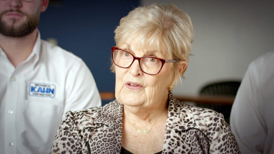 Screenshot from video of Ann Kahn and her family, seated in a studio setting, telling their story.
